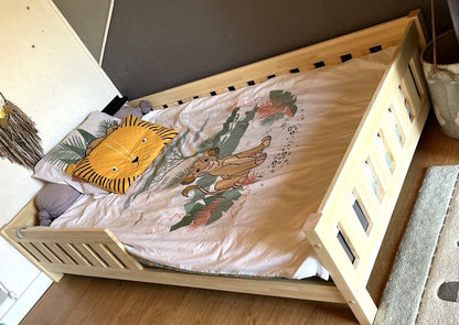 Simple children's bed with bars