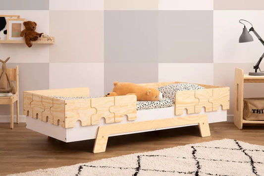 Children's bed with puzzle barriers