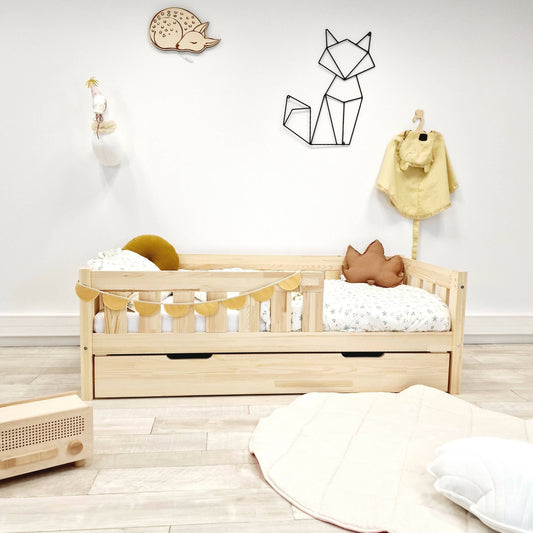 Simple child's bed with bars with drawer